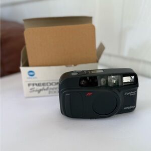 Vintage black Minolta Sightseer Zoom 35mm film camera with box retro